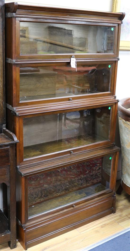 An Inglesants walnut four-section glazed bookcase flanked by reeded columns W.87cm